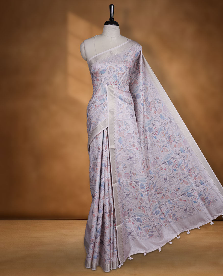 Light pink colour semi tussar silk saree featuring all over floral and leaf motifs on the body with a subtle self border and tasselled pallu, paired with a matching blouse.