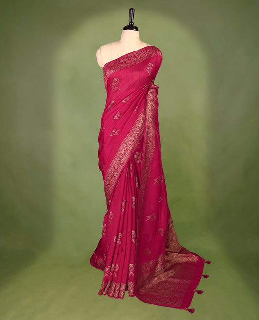 Deep Magenta colour semi Banaras tussar georgette saree embellished with antique zari flower motifs across the body, complemented by a rich Banaras border and paired with a matching blouse.