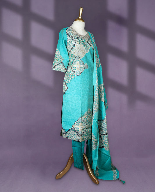 Turquoise colour salwar set with round neck and elbow sleeves featuring floral and tile inspired print with embroidered neckline paired with matching bottom and printed dupatta