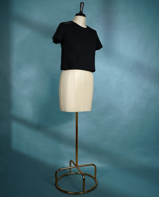 Black short sleeve T shirt with a round neck, featuring subtle stud detailing on the shoulders for a sleek, edgy twist on everyday comfort.