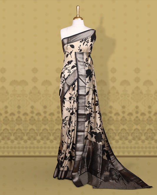 Beige colour saree adorned with bold black floral prints and a rich black zari border and stripped checkered pallu & Comes with a matching blouse piece.