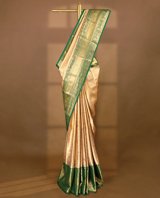 Gold colour tissue brocade saree with gold and silver zari flower and Diamond pattern on body, gold zari floral kodi work Green border, rich matching pallu with Antique zari motifs, paired with matching blouse.