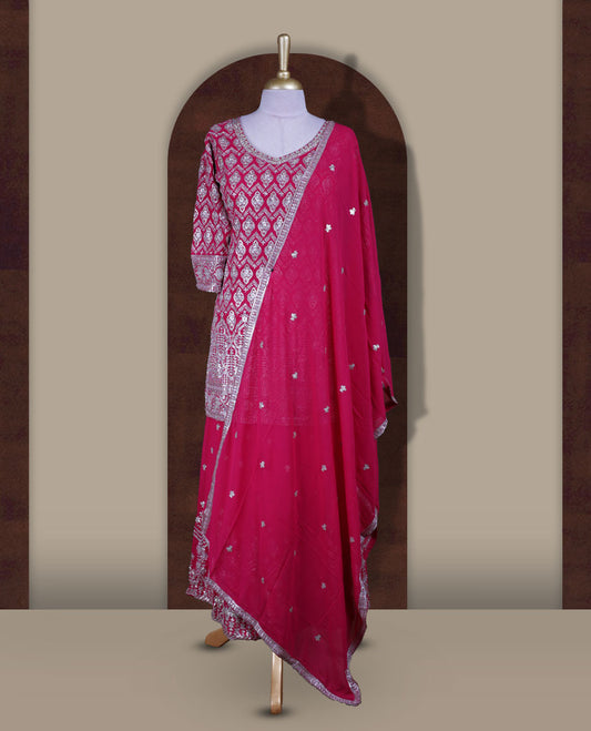 Elegant Magenta colour sharara set featuring a beautifully embroidered top with intricate silver and stone detailing, paired with a flowy flared bottom and a matching dupatta adorned with delicate sequin work.