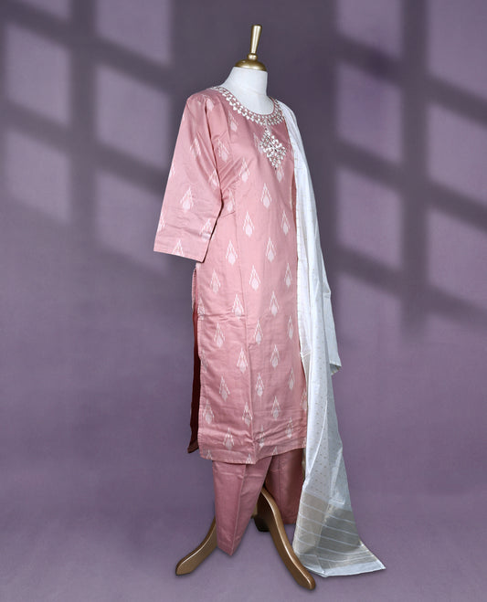 Dusty pink colour salwar set featuring ikat style motifs and delicate mirror work on the neckline, paired with matching plain bottom and an elegant off white dupatta with subtle golden thread detailing.