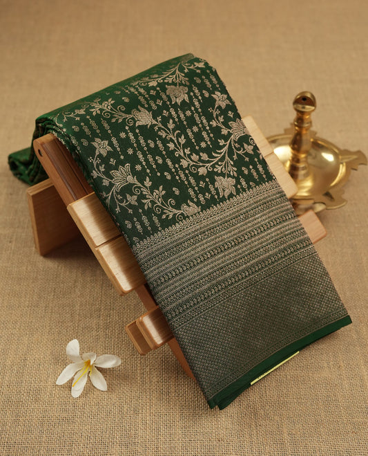 Bottle green colour Kanchipuram pattern Manthrakodi saree featuring kodi floral antique zari jacquard all over, geometric turning border and self zari blouse piece.