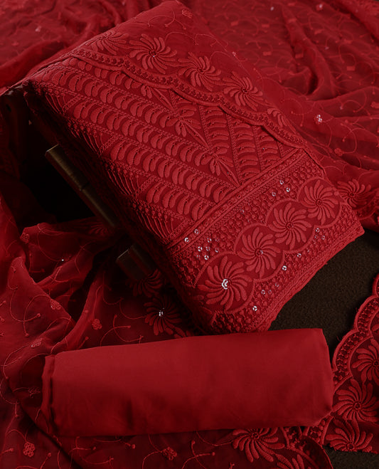 Stunning deep red churidhar material embellished with intricate floral embroidery and subtle sequin detailing, paired with a plain matching bottom and beautifully embroidered dupatta, ideal for festive and grand occasions.