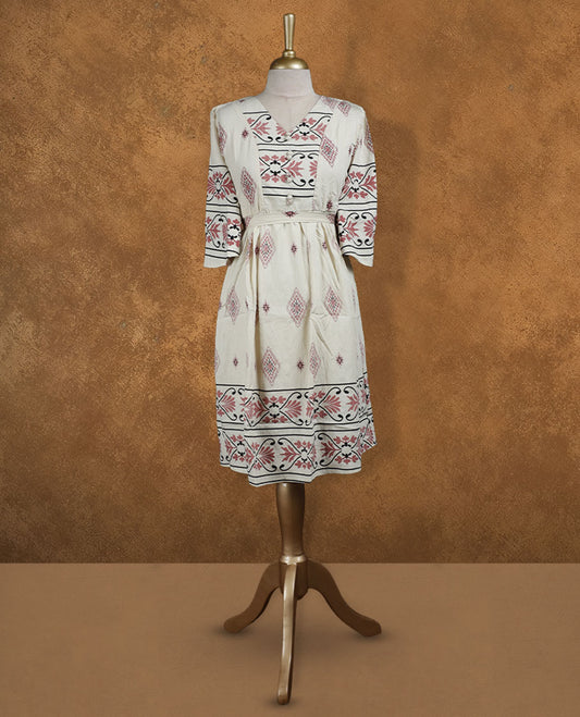 Ivory printed knee-length A-line dress with V-neckline, rose and black ethnic motifs, three-quarter sleeves, and a detachable waist belt for a cinched silhouette.