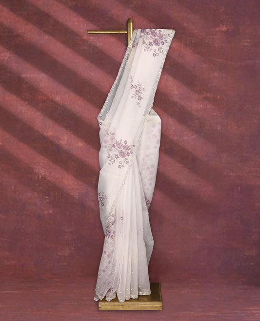 White colour pure organza saree featuring Grape Colour floral prints with intricate bead and sequin work across the body, adorned with a matching embellished border, complemented by a worked pallu and paired with a heavily worked matching blouse.