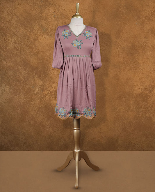 Dusty mauve knee-length A-line dress with V-neckline, pastel floral embroidery on yoke and scalloped hem, and elbow-length gathered sleeves.