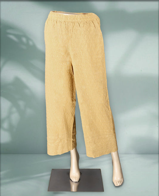 Beige colour palazzo pants featuring intricate self embroidery and a relaxed, flowy fit