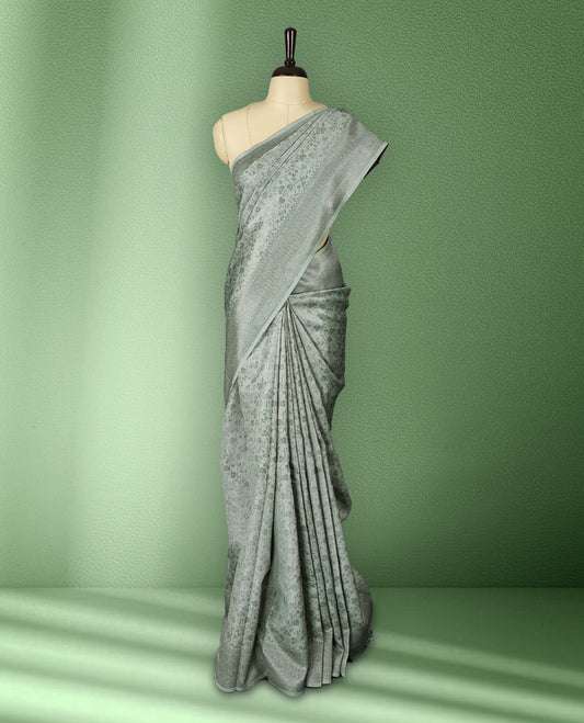 Light Pastel Green colour semi silk saree featuring neem zari floral kodi motifs all over the body, complemented by a rich self colour woven border, with matching blouse.
