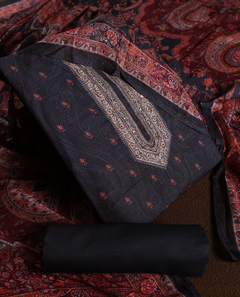 Black colour churidhar material with elegant maroon embroidery and delicate motifs, complemented by a plain matching bottom and dupatta.