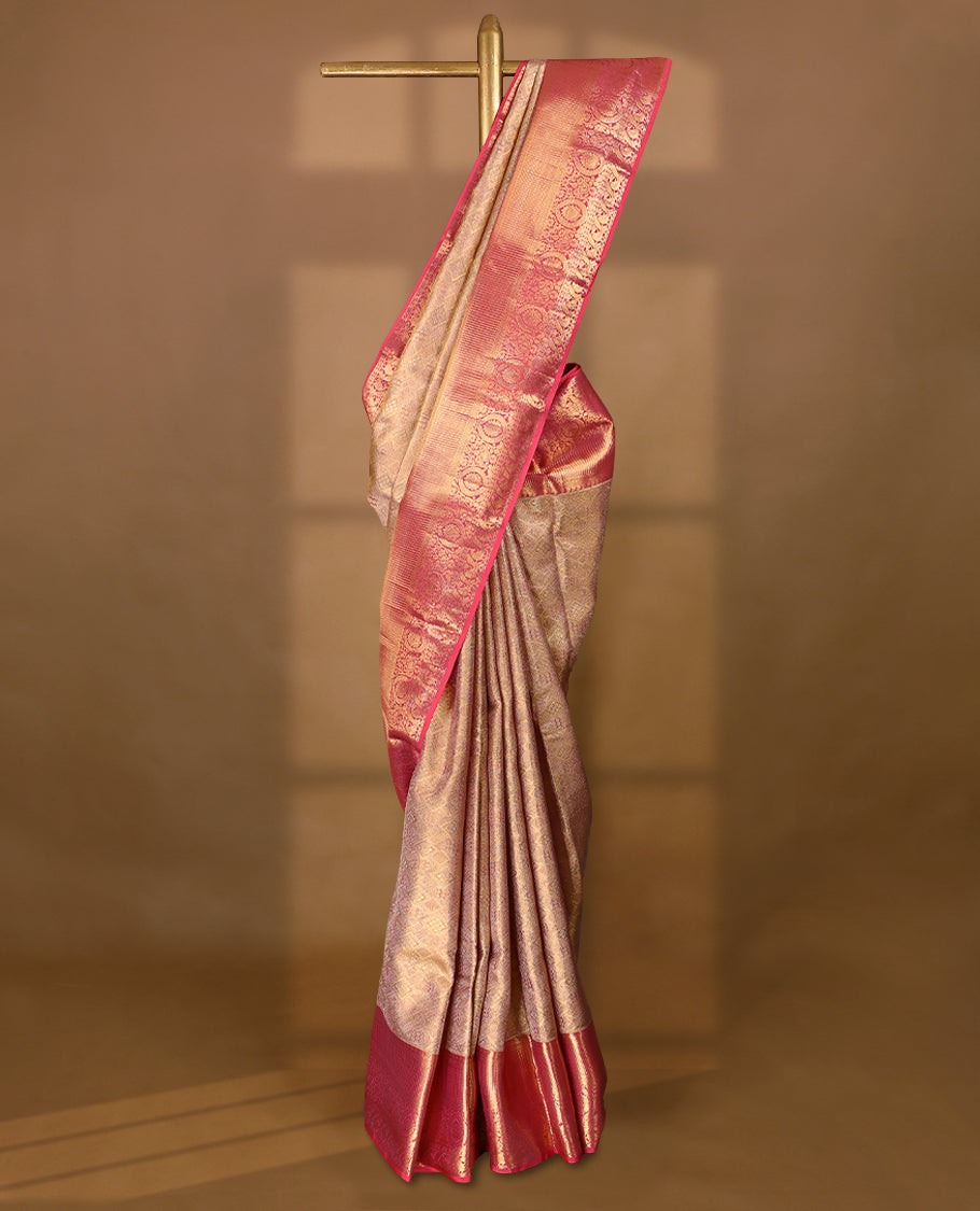 Golden Colour Kancheepuram tissue silk saree featuring intricate silver and pink Zari diamond motifs on the body, beautifully complemented by a contrasting traditional peacock and floral kodi design border, paired with a matching blouse.