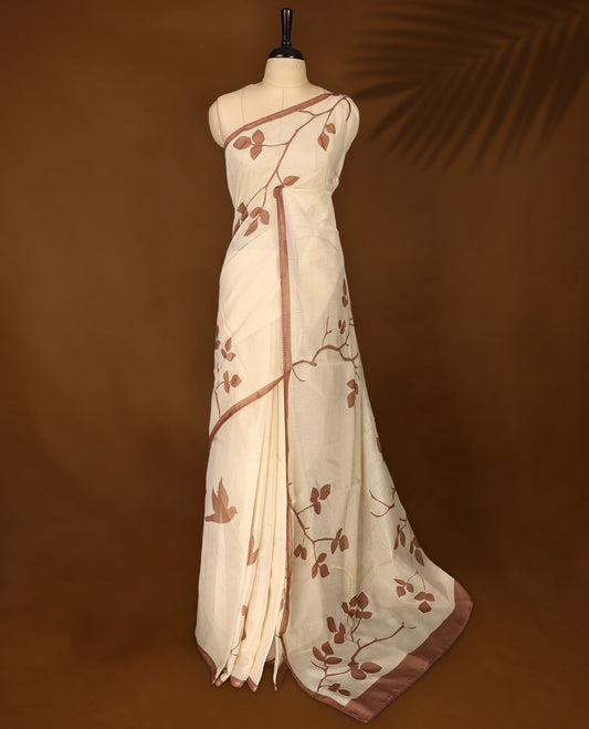 Cream colour Tussar cotton Kota saree featuring delicate Block printed leaves motifs across the body, highlighted with a subtle brown border, paired with a matching blouse.