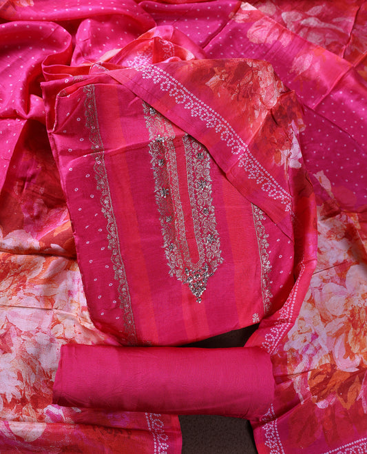 Vibrant pink colour churidhar material with intricate embroidery on the neckline and delicate floral prints, paired with a matching printed dupatta and a plain bottom.