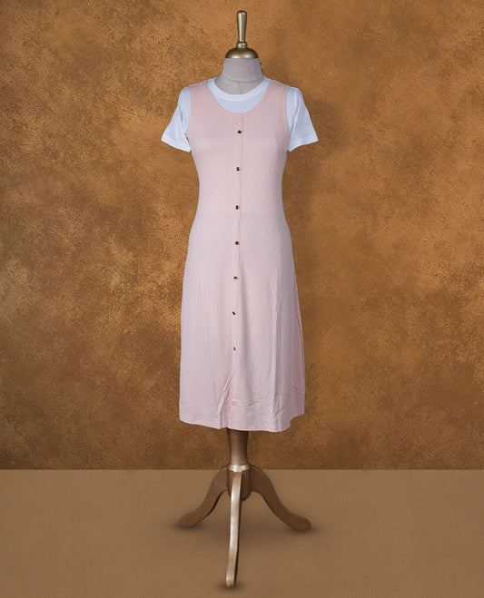 Blush pink sleeveless A-line midi dress with front button detailing, layered over a white crew-neck short-sleeve inner tee