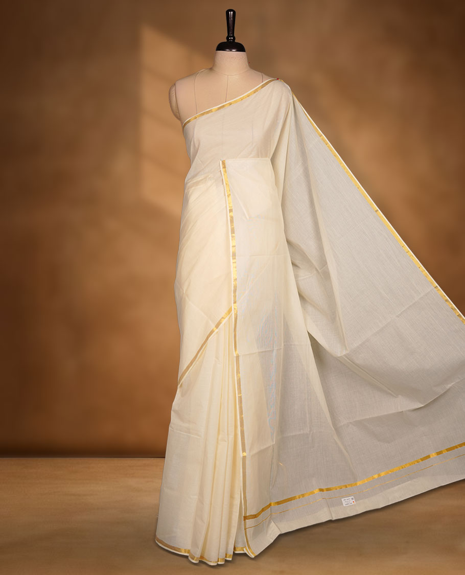 Off-white colour cotton Kerala saree with a subtle gold kasavu border, featuring a clean, plain body and airy texture, paired with a matching blouse.