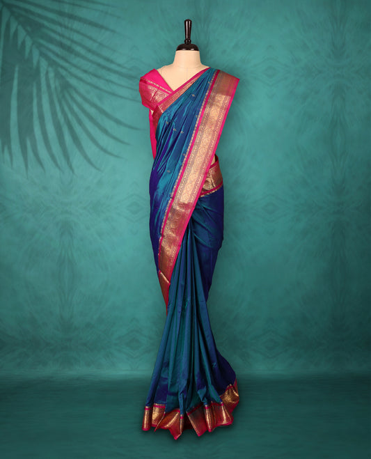 Peacock Blue colour Traditional Kancheepuram Silk saree with small gold motifs on body, Magenta traditional border with intricate gold zari weaving, grand zari pallu, perfect for Bharatanatyam, with matching blouse.