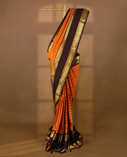Rust orange Colour pure traditional Kancheepuram silk saree adorned with antique zari horizontal lines on the body, elegantly complemented by a traditional border, and paired with a matching blouse.