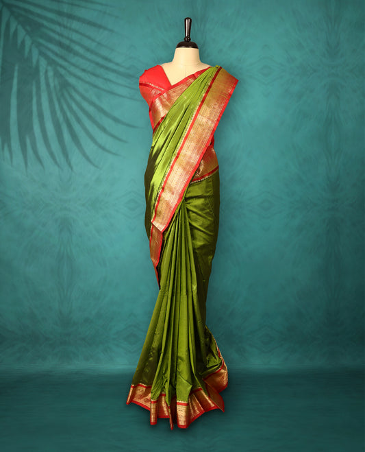 Olive Green colour Traditional Kancheepuram Silk saree with small gold motifs on body, Deep Red traditional border with intricate gold zari weaving, grand zari pallu, perfect for Bharatanatyam, with matching blouse.