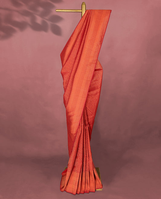 Chilli Red colour Kancheepuram saree featuring an antique zari brocade body, complemented by a traditional border and a matching blouse.