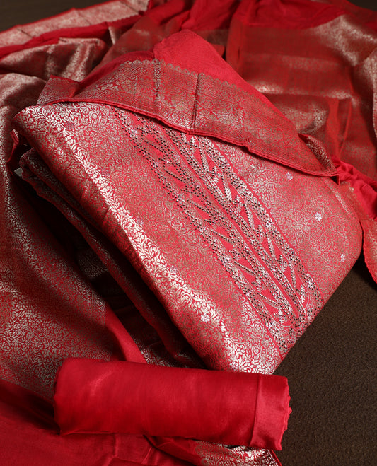 Maroon colour churidhar material with elegant golden zari floral weaves and stone embellishments, paired with a plain matching bottom and dupatta.