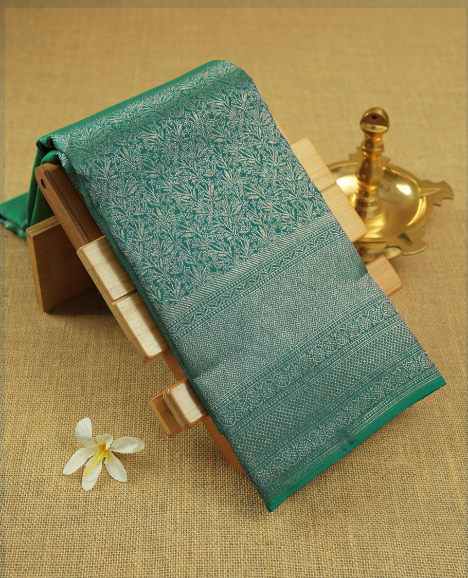Peacock green colour Kanchipuram pattern Manthrakodi saree featuring floral and leaf motifs zari kodi antique gold jacquard kanchipuram traditional & zari turning border and zari jacquard blouse piece.