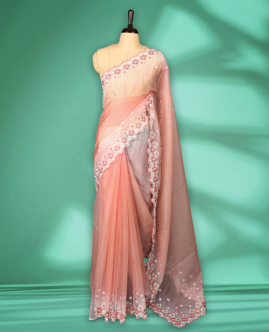Peach and White colour double shade organza saree with delicate floral embroidery on body, intricately embroidered scallop border, floral embroidered design on pallu, with matching blouse