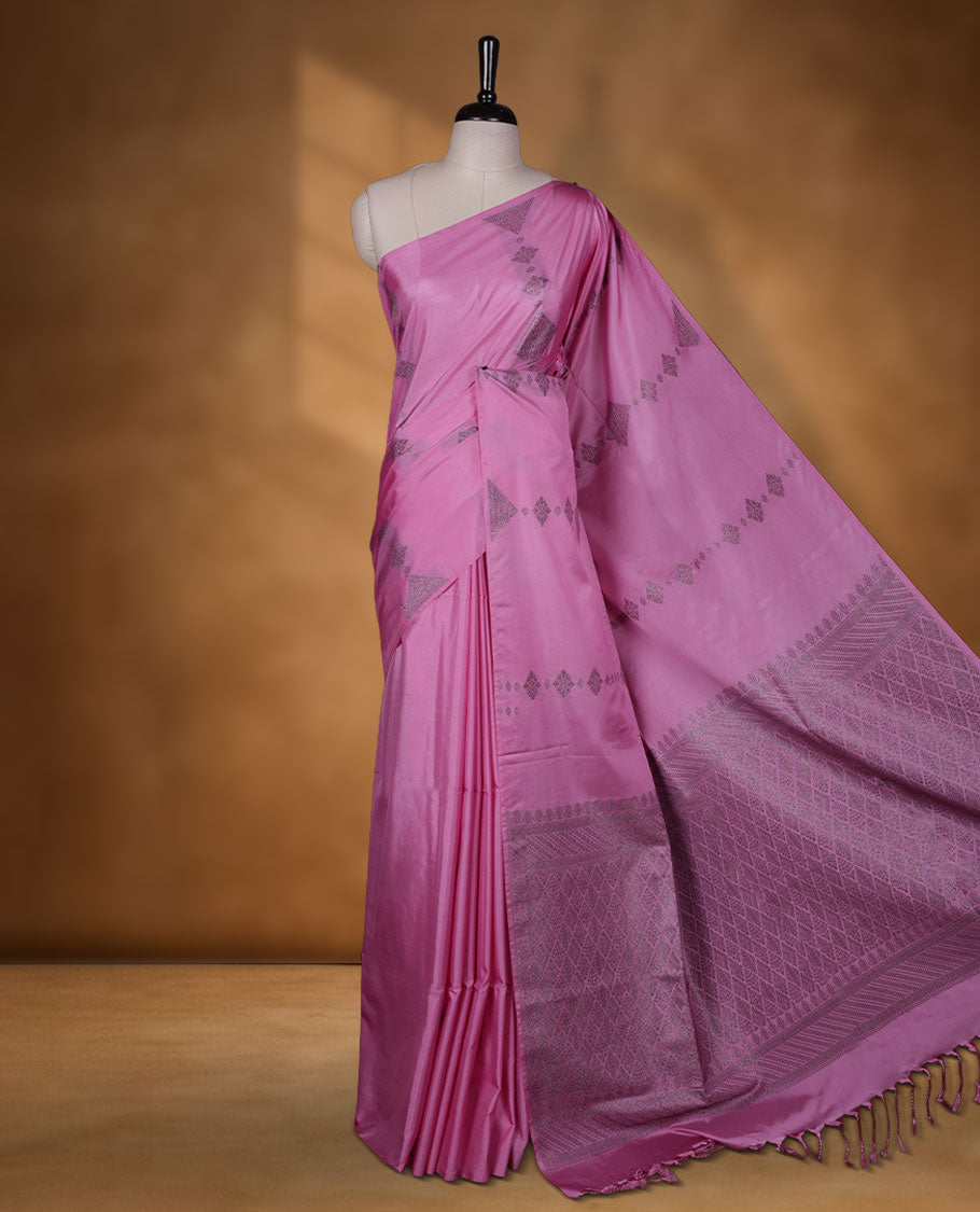 Pink colour semi soft silk saree adorned with delicate woven Diamond motifs on the body, complemented by a Self colour woven pallu with intricate detailing and tassel accents without border & Comes with a matching blouse piece.