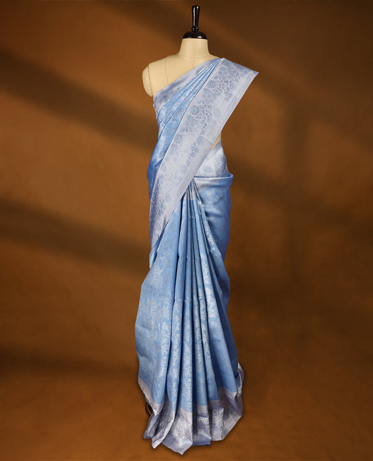 Pastel Blue coloured semi silk saree featuring a Silver coloured Zari design on the body, paired with a Baby Blue coloured border and matching blouse.