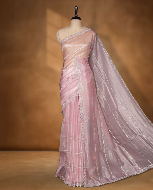 Pastel pink Colour net shimmer fancy saree adorned with white stone buttas with design over the body, paired with a delicate stone worked border and matching blouse