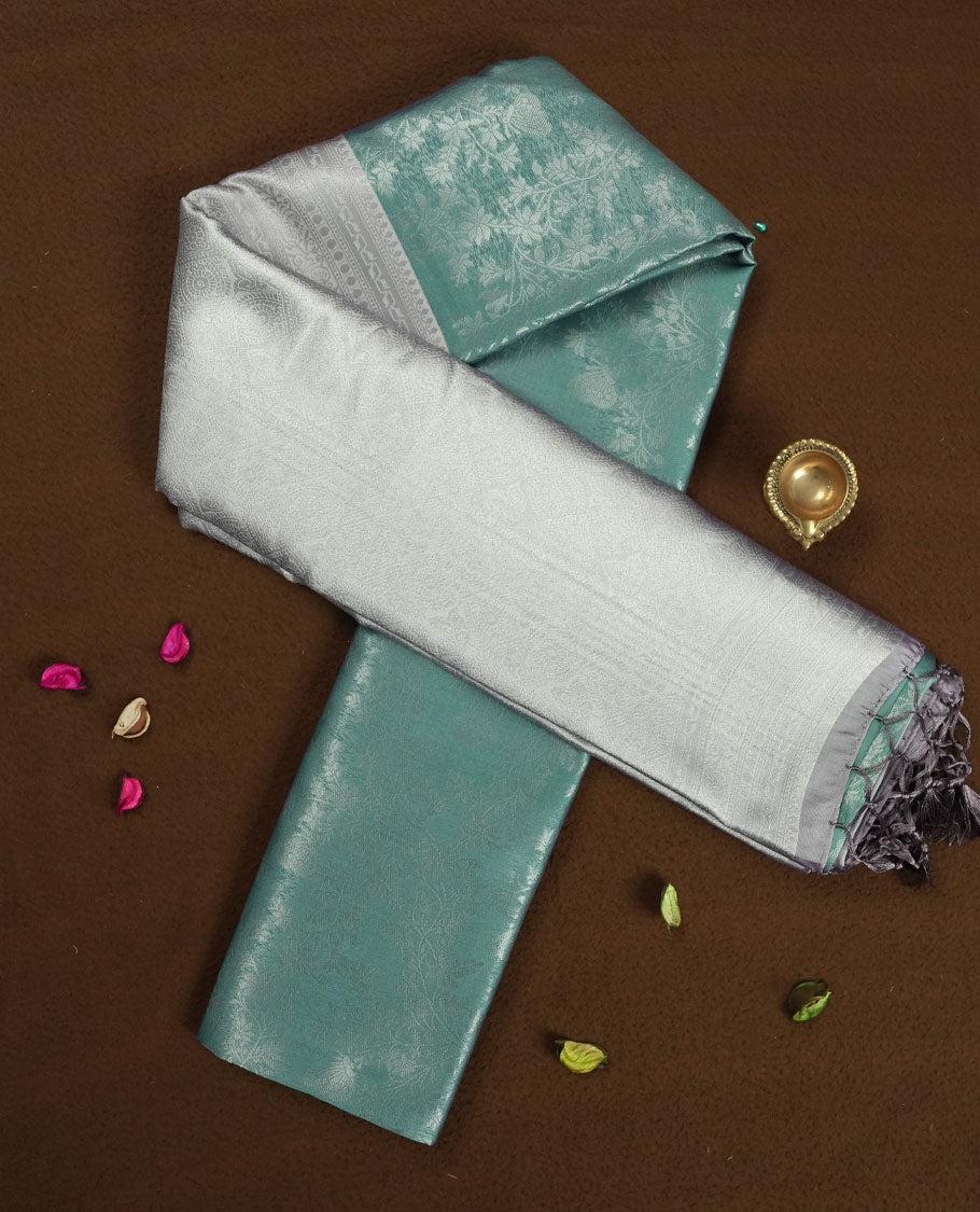 Seafoam Green colour Semi Silk Saree with Allover Subtle Floral Self-Weave on the Body, Contrasting Silver Zari Woven Pallu and Border Featuring Intricate Geometric Motifs and Tassels, Paired with Coordinated Blouse Piece