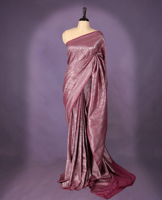 Onion colour semi Banaras Katan saree featuring an antique silver zari jacquard body, complemented by a self colour traditional border with a floral kodi design, paired with a matching blouse