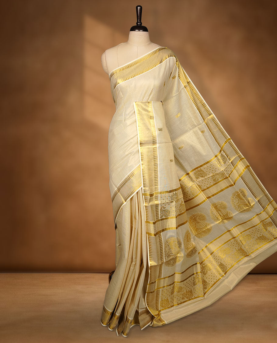 Elegant off-white Kerala saree featuring subtle gold zari buttas across the body, a refined kasavu border with traditional detailing, and a richly woven pallu, paired with a matching blouse