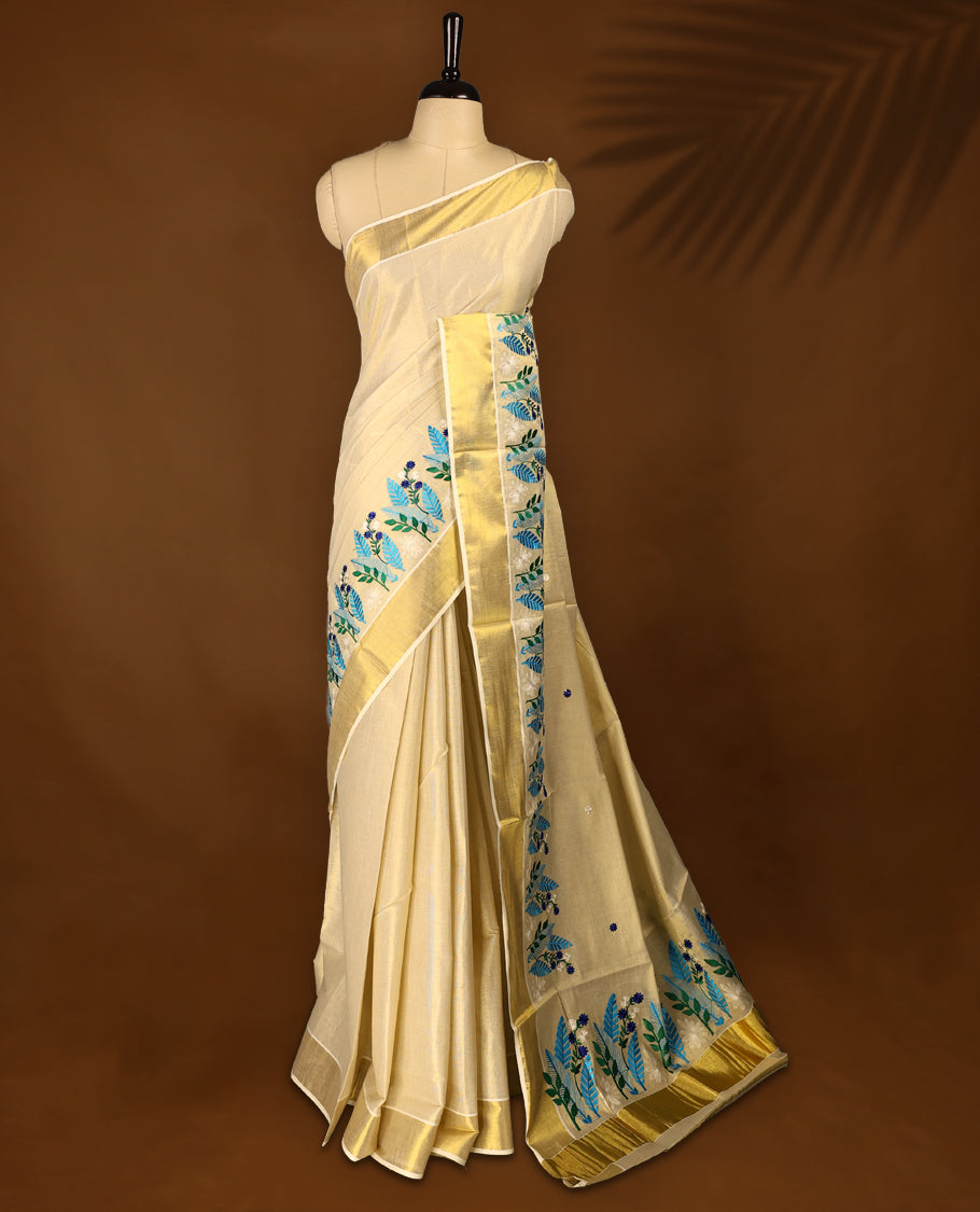 Light Gold colour Tissue Kerala saree featuring Plain body and a beautifully woven Gold Kasavu border with multi  colour Heavy Floral embroidery work, paired with a matching blouse perfect for festive occasions.