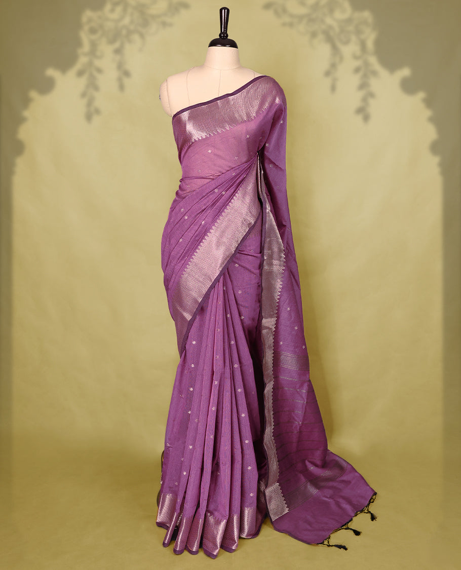 Pastel Purple colour Chanderi cotton saree adorned with delicate Golden Flower motifs on the body, paired with a traditional Mangalagiri style golden zari border with matching blouse.
