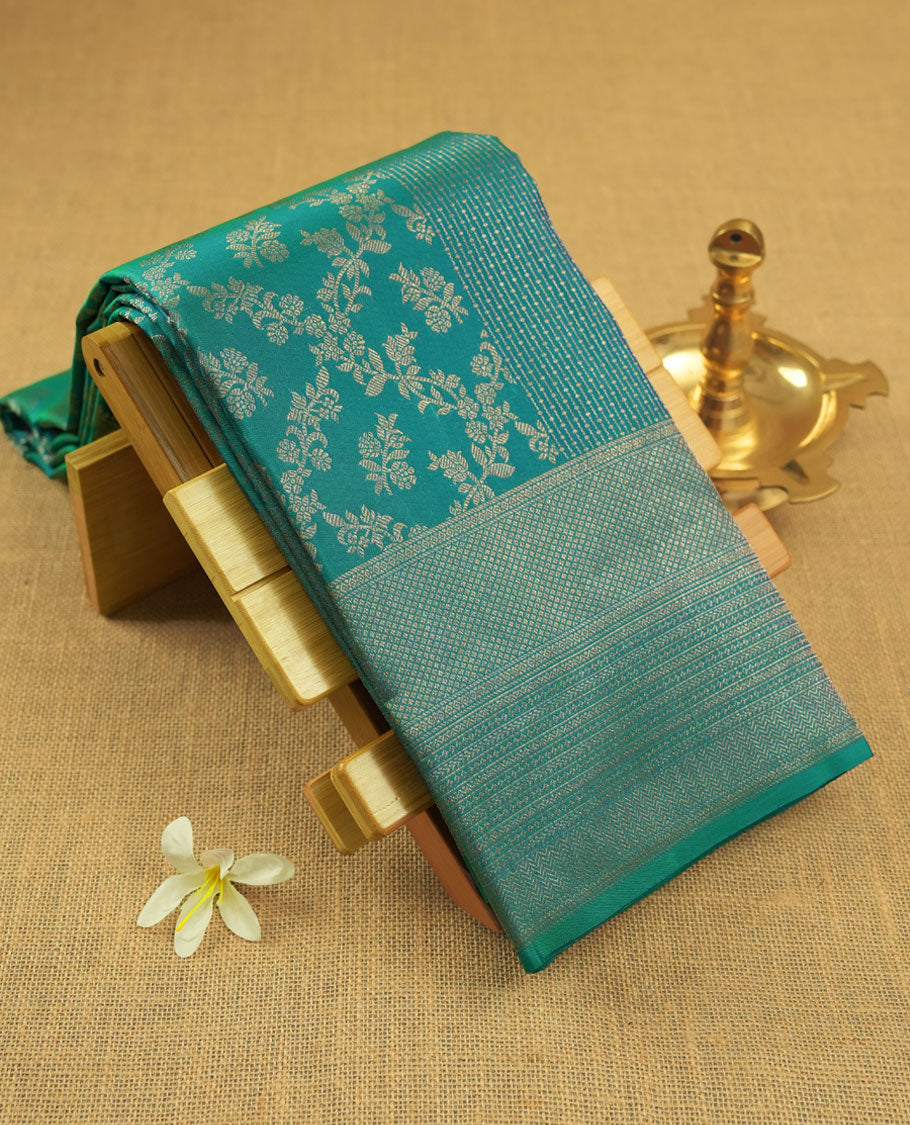 Peacock blue colour Kanchipuram pattern Manthrakodi saree with double pattern zari jacquard body, antique zari floral design, vertical oosi lines with diamond motifs, elegant zari border, and self jacquard blouse piece.