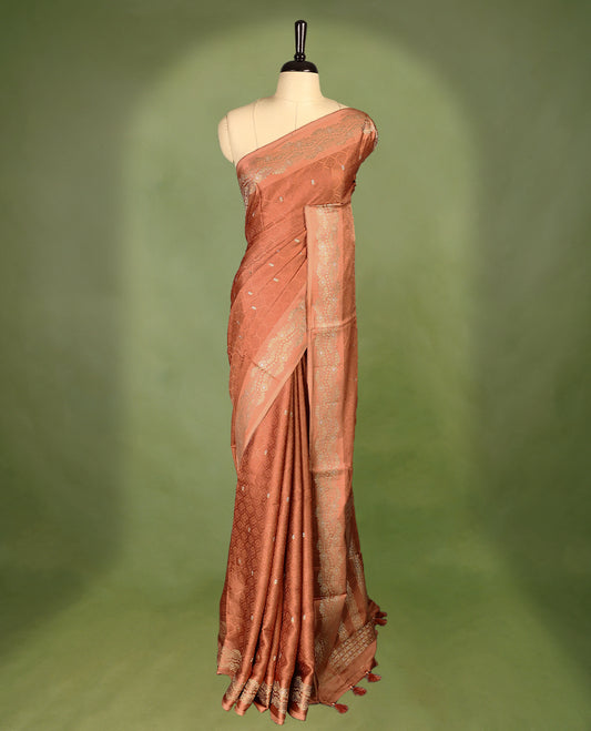 Pastel Brown colour pure Banaras crepe saree showcases elegant Gold & Silver zari Motifs all over the body, a traditional gold & Silver zari border, a rich intricately woven pallu, and comes with a matching blouse.