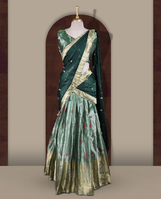 Light green colour Dhavani set featuring a Green colour skirt with contrast Gold colour border with rich gold zari pattern, paired with a Matching dupatta detailed with Gold motifs