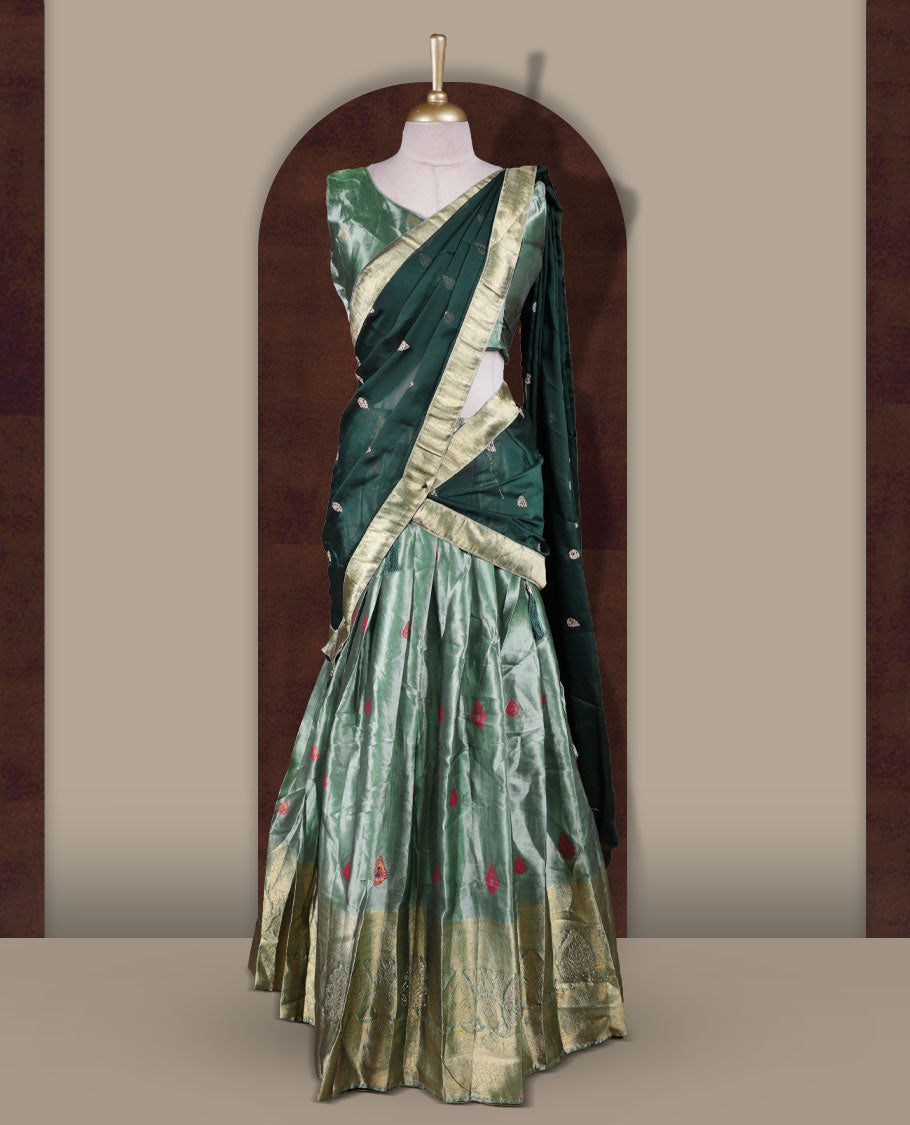 Light green colour Dhavani set featuring a Green colour skirt with contrast Gold colour border with rich gold zari pattern, paired with a Matching dupatta detailed with Gold motifs