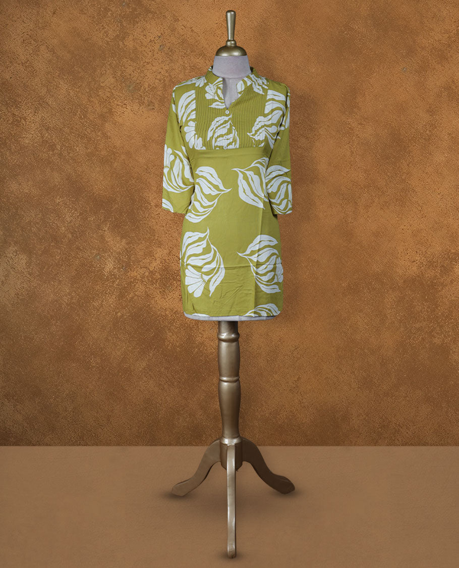 Light olive green floral printed medium-length kurti with band collar, pintuck yoke detailing, three-quarter sleeves, and straight hemline.