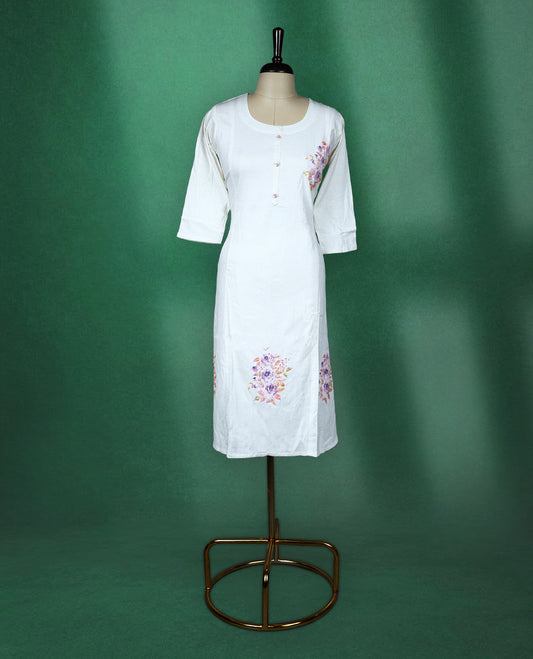 White colour cotton kurti featuring delicate floral prints in soft pastel shades with beads ans sequence work, scoop neckline with button detailing, and elbow length sleeves perfect for a graceful and breezy everyday look.