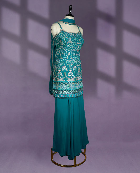 Stunning teal colour sharara set featuring intricate floral embroidery, flowy sharara pants, and a matching dupatta perfect for festive occasions