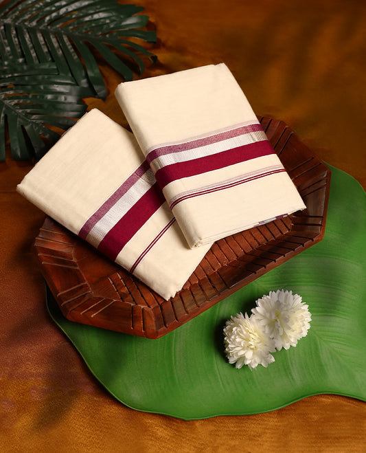 Off white colour cotton SET MUNDU featuring a plain body, complemented by a bold Deep Red and silver toned border( 2.00/2.80 MTS ).