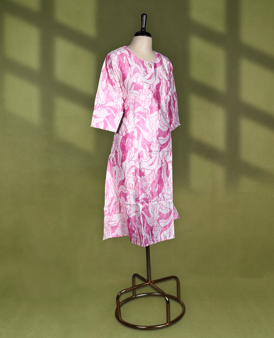Off White and pink printed straight cut kurti featuring bold floral patterns all over, styled with a round neckline, keyhole detail, and 3/4th sleeves, perfect for a fresh and casual everyday look.