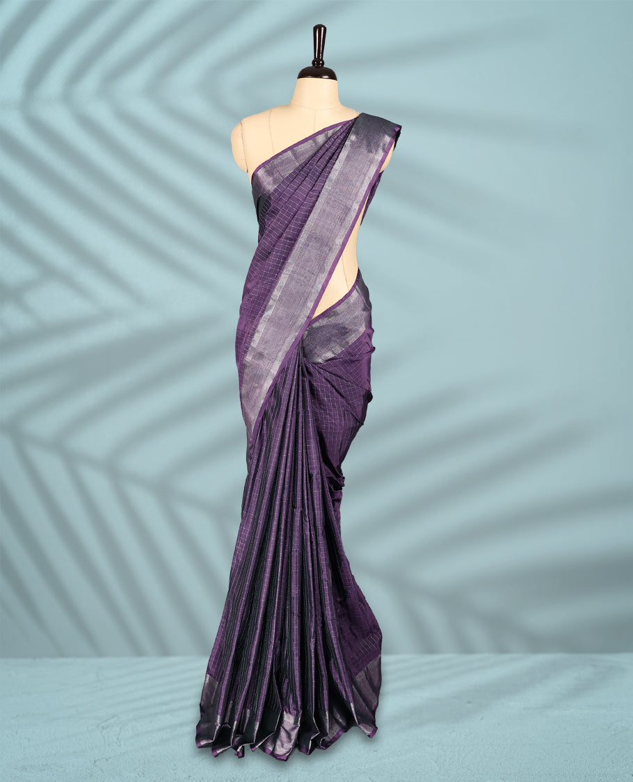 Dusty purple colour semi silk saree featuring silver checkered weave patterns on the body, complemented by a sleek silver zari border, and comes with a matching blouse.