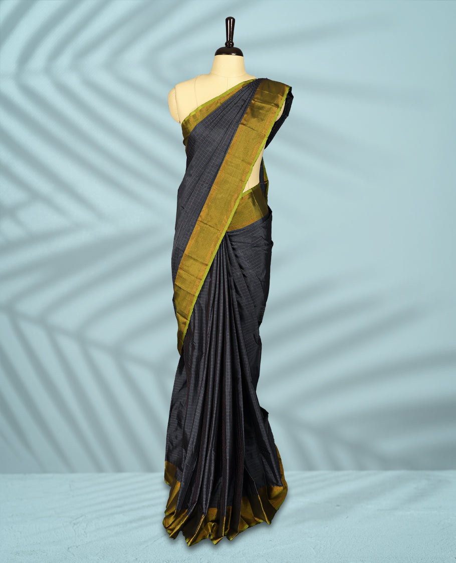 Charcoal grey Colour semi silk saree features a subtle copper zari check pattern, beautifully accented with a copper & olive green border, and comes with a matching blouse