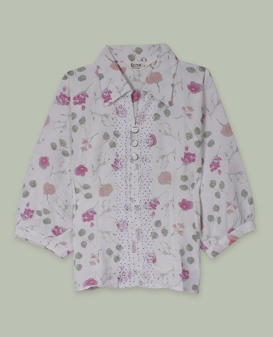 White floral printed shirt top with collared neckline, three-quarter sleeves, and front button placket framed by embroidered lace detailing.