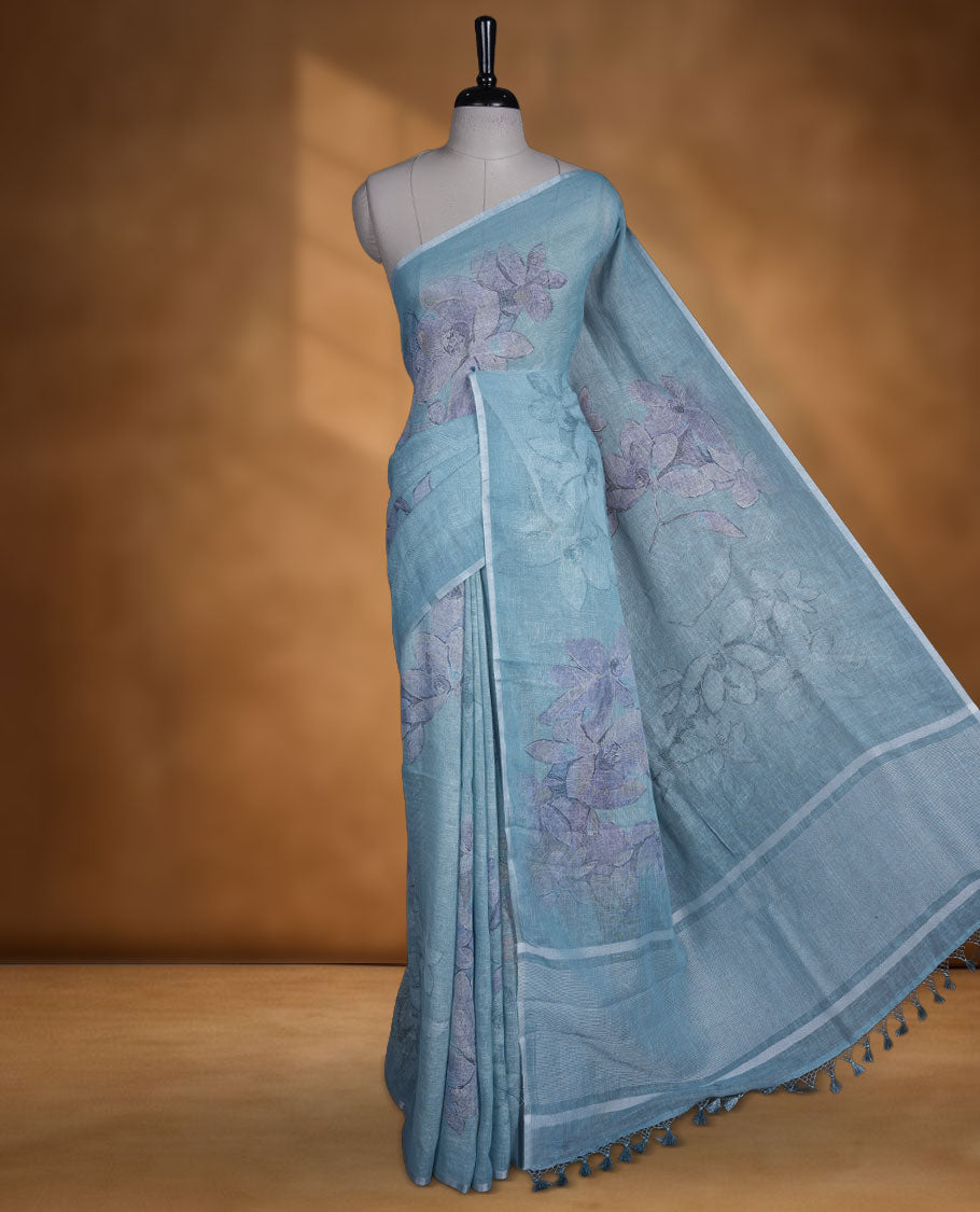 Ice blue colour pure linen saree featuring Floral print pattern across body, silver thin border finished with matching blouse.
