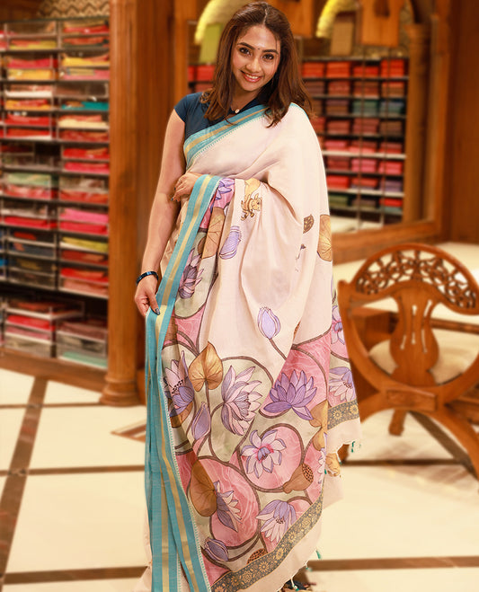 Off-white Colour lightweight khadi cotton saree featuring earthy-coloured digital floral kodi prints on the body and pallu, accented with a Blue border paired with a matching blouse.
